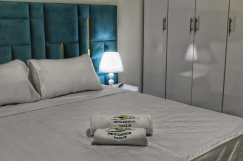 a bedroom with a bed with two towels on it at Yassers Residence in Er Rachidia