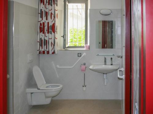 a bathroom with a toilet and a sink at Gite La Sempesserre in Monjoi