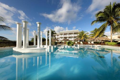 a swimming pool with a resort in the background at Grand Palladium Jamaica Resort & Spa All Inclusive in Lucea