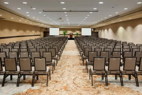an empty room with chairs and screens in it at Sheraton Waikiki Beach Resort in Honolulu