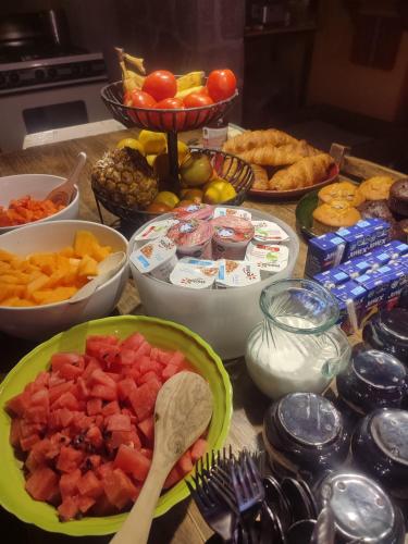 a table topped with bowls of fruit and other foods at Habitación#6 con doble vista jardín in Querétaro