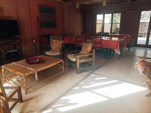 a dining room with tables and chairs and a television at La Elegida in Tilcara