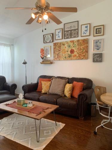 a living room with a couch and a coffee table at Charming 2 bdr 1 bath home fenced byard N Pensacola Pet Friendly Close to bases in Pensacola