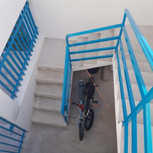 a bike is tied to a staircase with a rope at Estudio Coatí Azul en la Isla de Cozumel en el Caribe in Cozumel