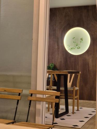 a table and chairs in a room with a light at Soban Stay in Busan