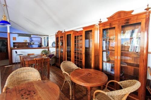 a room with wooden furniture and tables and chairs at Borgo Marino Plemmirio in Siracusa