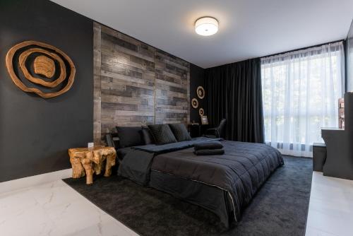 a bedroom with a large bed with a wooden wall at MONROE APART HOTEl in Hollywood