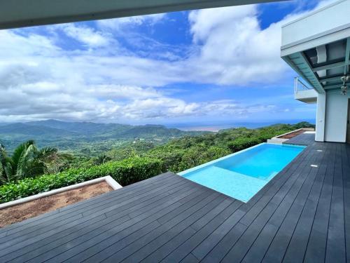 a house with a swimming pool on a wooden deck at Casa yin yang in Carrillo