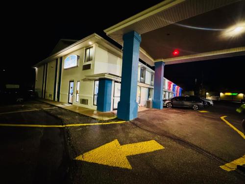 an empty parking lot in front of a building at night at Express inn Junction city in Junction City