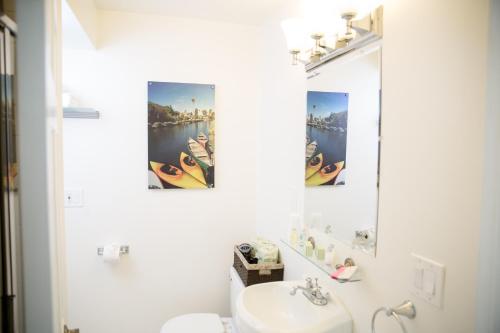 a white bathroom with a sink and a mirror at Venice on the Beach Hotel in Los Angeles