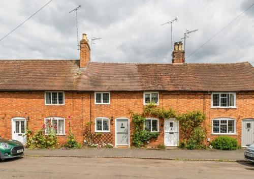 a red brick house with white doors and windows at Poppy Cottage - Cosy 2 Bedroom, Perfect for Family! in Shottery