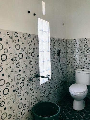a bathroom with a toilet and a shower at Princess Villa in Pasirjambu