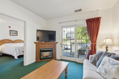 a living room with a couch and a fireplace at Grand Wood Suites - 1st Floor Front Side Suite 104 in Nashville