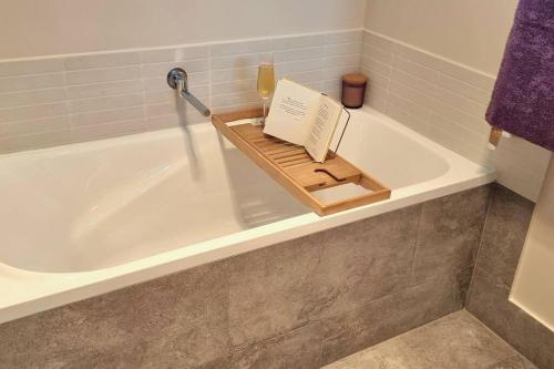 a book sitting on top of a bath tub at Island House in Albany