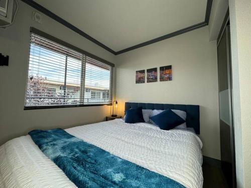 a bedroom with a large bed and a window at Modern condo near Fremont Street in Las Vegas