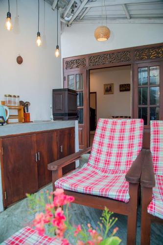 a living room with a table and a chair at Shiny Villa in Unawatuna