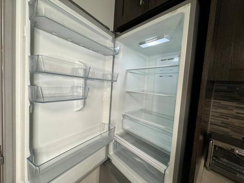 an empty refrigerator with its door open in a kitchen at Modern condo near Fremont Street in Las Vegas