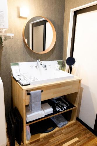 a bathroom with a sink and a mirror at Haru in Goto
