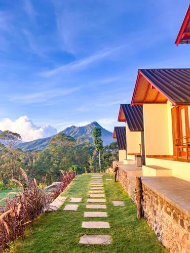 a house with a stone pathway leading to a house at Bali Sunrise Cabin in Bangli