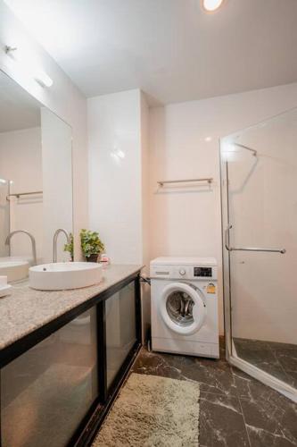 a bathroom with a sink and a washing machine at Lux apartments TOP in Koh Samui