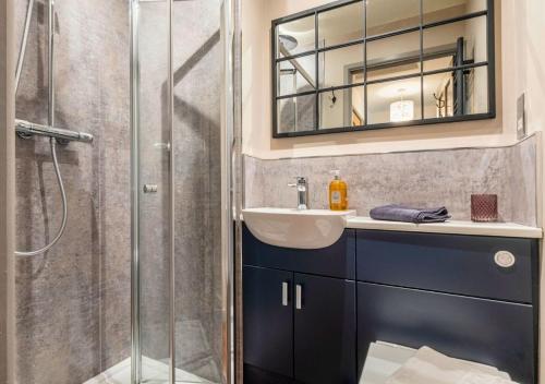 a bathroom with a shower and a sink and a mirror at Gorgeous Rural 4 Bed Farm Cottage - With Hot Tub! in Norton Saint Philip