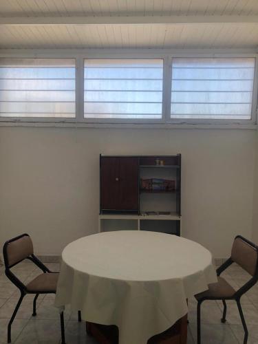 a room with a white table and two chairs at El Solaz en la Ciudad in San Juan