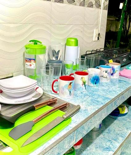 a counter with plates and utensils on a table at Casa Turística la Villa de Poli in Guaduas
