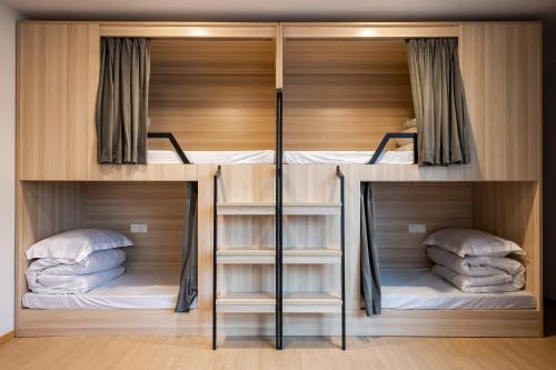 two bunk beds with their doors open in a room at Dayin Garden Hotel -People's Square & Nanjing Road-Large Social Area -Bar -Café -Gym -Free Laundry Luggage Storage -24H Front Desk-English Service in Shanghai