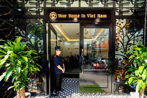 a man standing in the doorway of a building at Dream Premium Hotel & Spa in Hanoi