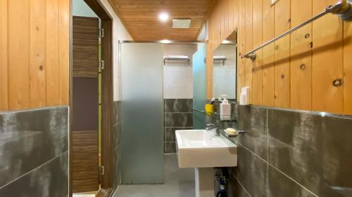 a bathroom with a sink and a shower at Backpacker's Home in Seogwipo