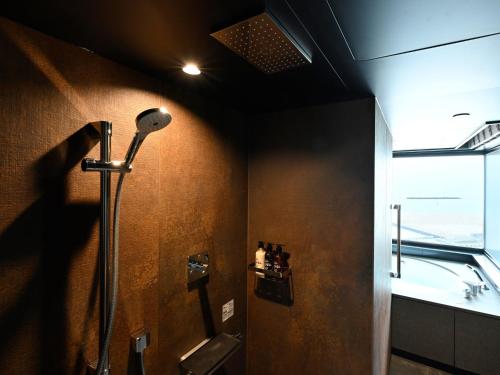 a shower stall in a bathroom with a window at Kobe Suma Seaworld Hotel in Kobe