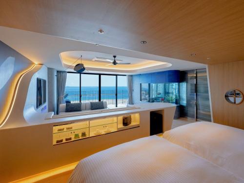 a bedroom with two beds and a view of the ocean at Kobe Suma Seaworld Hotel in Kobe