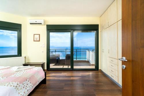 a bedroom with a bed and a balcony at Azure in Kallirakhi