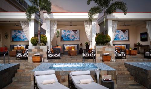 a lobby of a hotel with chairs and a fountain at Solaire Resort Entertainment City in Manila