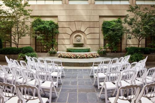 a bunch of white chairs in front of a fountain at Westin Georgetown, Washington D.C. in Washington