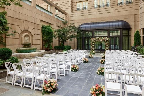 a row of white chairs in front of a building at Westin Georgetown, Washington D.C. in Washington