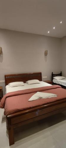 a bedroom with two beds with red sheets at Ecovilla luxury in Pondicherry