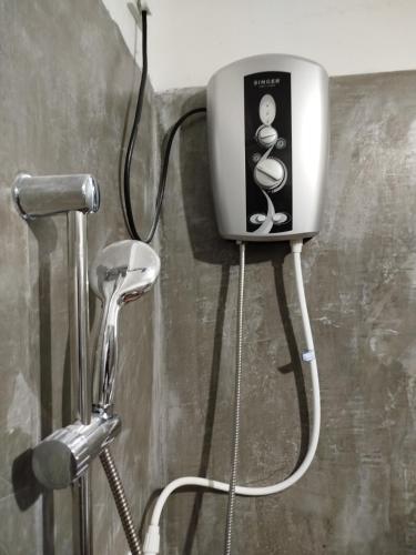 a soap dispenser on the wall of a shower at Guruge villa in Hikkaduwa