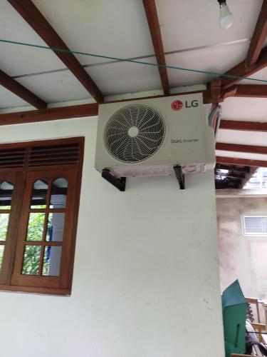 a fan on the ceiling of a room at Guruge villa in Hikkaduwa