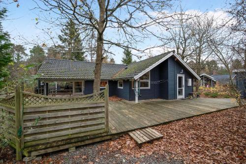 a blue house with a wooden fence in front of it at Stunning Home In Rønde With 3 Bedrooms And Wifi in Rønde