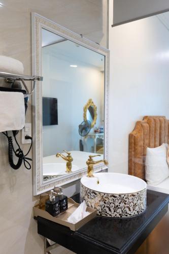 a bathroom with a sink and a mirror at Royal Hotel Thanh Trì in Hanoi