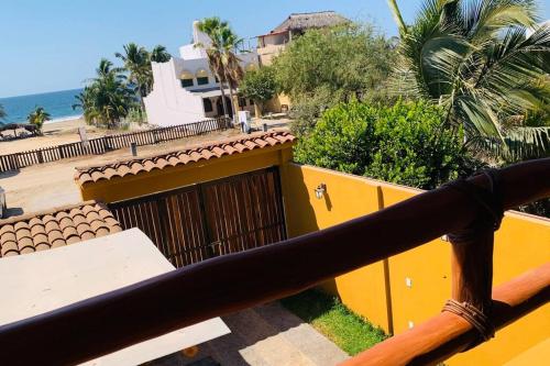 a view of the beach from the balcony of a house at Casa Hipocampo a pasos de la playa in Ixtapa-Zihuatanejo International