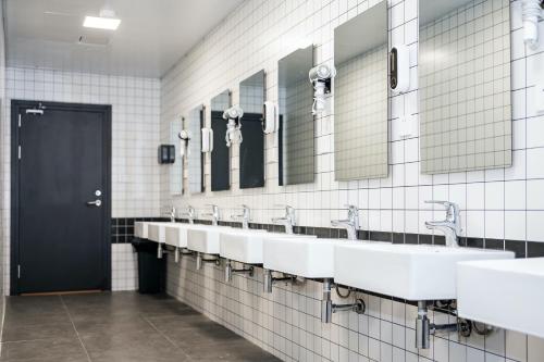 a bathroom with a row of sinks and mirrors at Dayin Garden Hotel -People's Square & Nanjing Road-Large Social Area -Bar -Café -Gym -Free Laundry Luggage Storage -24H Front Desk-English Service in Shanghai