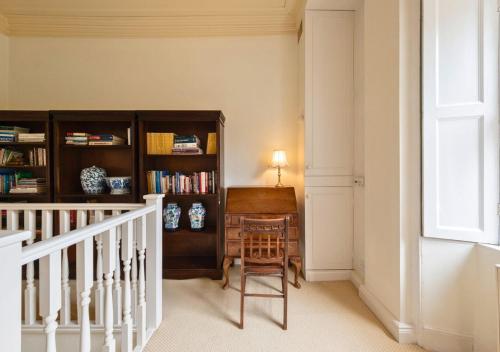 a staircase with a chair and a desk in a room at Gorgeous 3BD in Oxfordshire - Stunning Countryside! in Steeple Aston