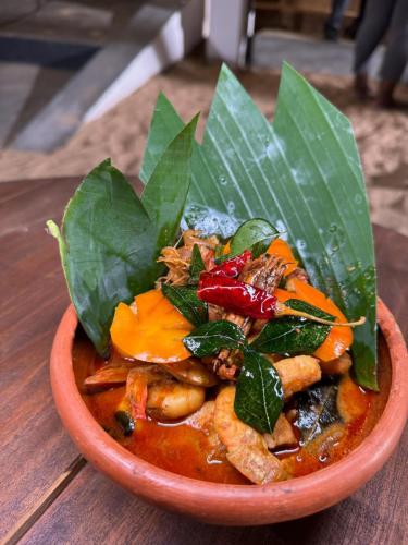 a bowl of food on a wooden table at Eleven 11 resort in Tangalle