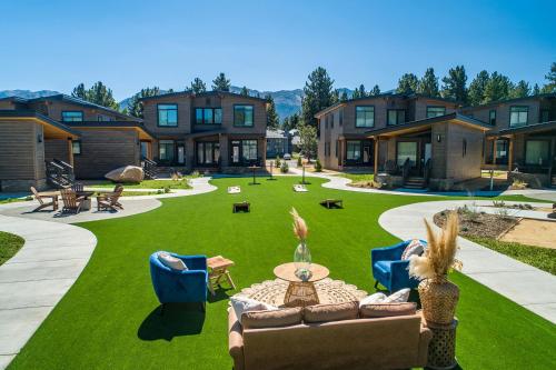 a yard with a couch and chairs on the grass at Outbound Mammoth in Mammoth Lakes
