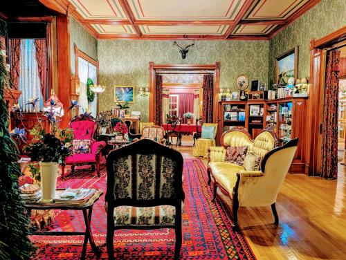 a living room filled with lots of furniture at Alexander Mansion Bed & Breakfast in Winona