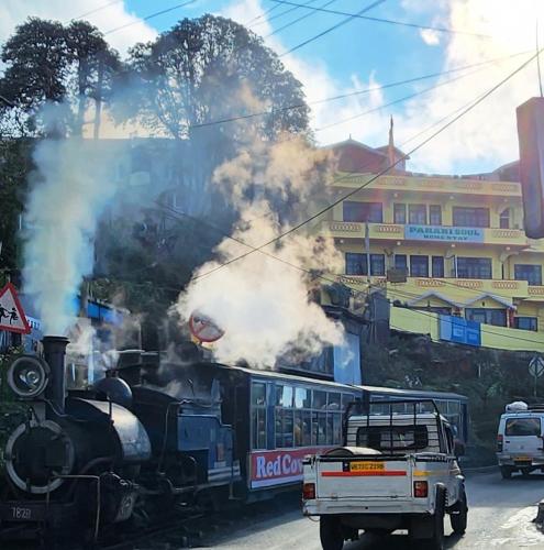 a steam engine train with smoke coming out of it at Pahari Soul in Darjeeling