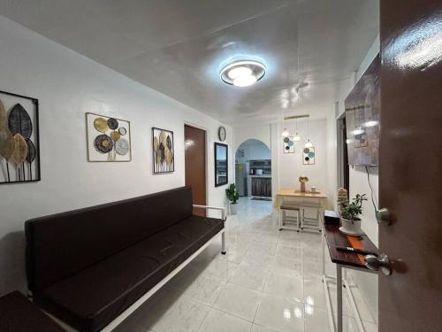a living room with a couch and a table at ACL Staycation Home in Imus & Kawit with portable pool unit 2 in Kawit