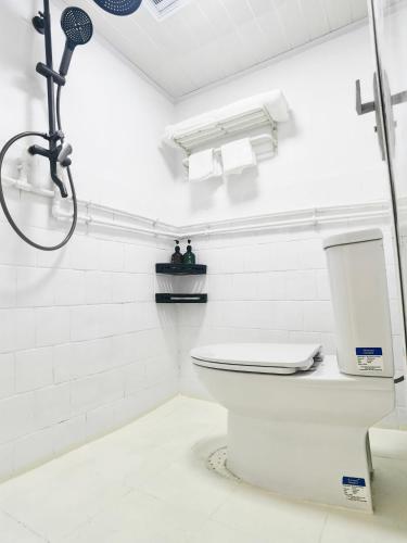 a white bathroom with a toilet and a shower at Seeking Flavors in Chengdu t aishengnanlu road in Chengdu